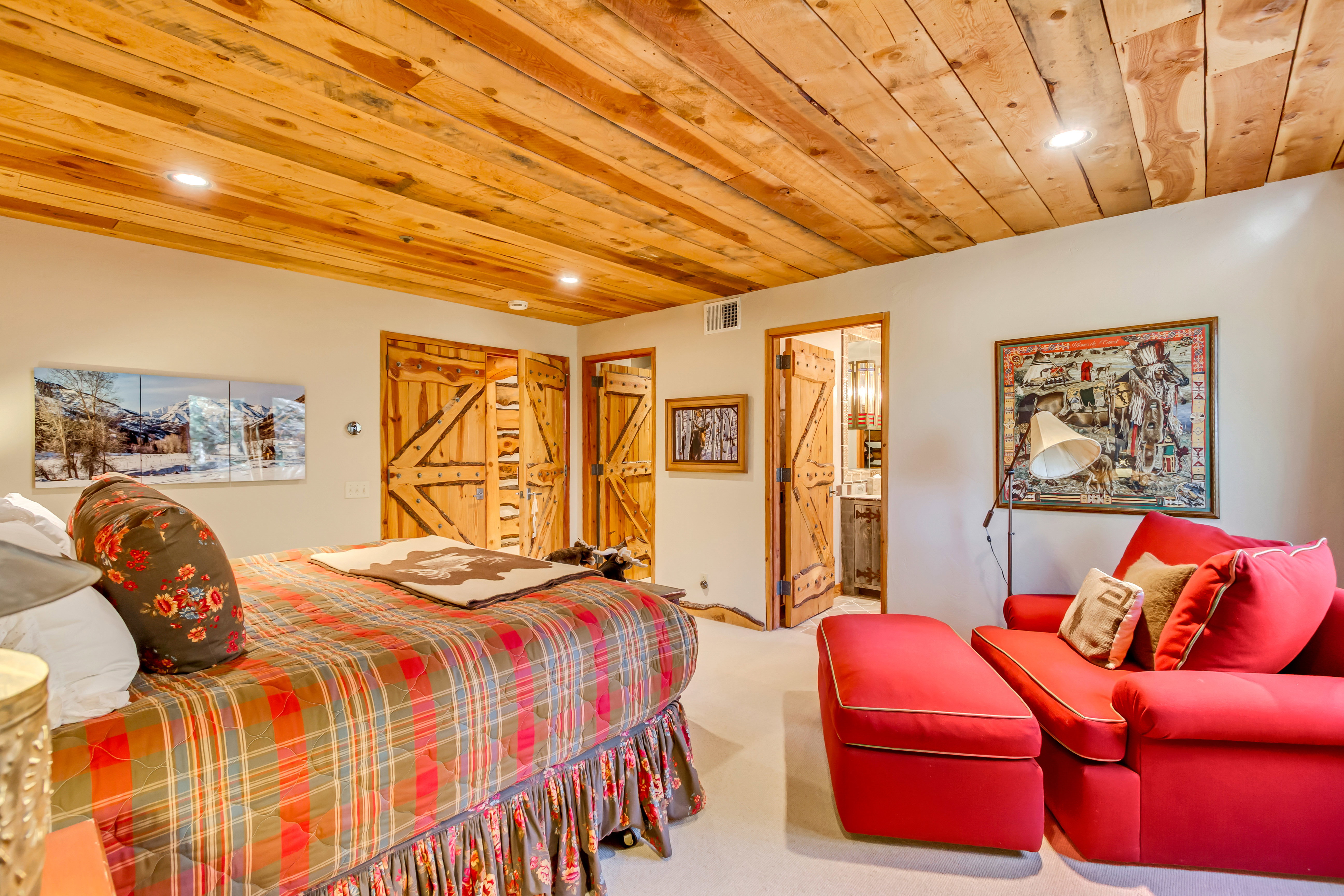 Carpeted bedroom with wooden ceiling, recessed lighting, and ensuite bathroom