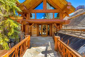 Entrance to property with french doors and log siding