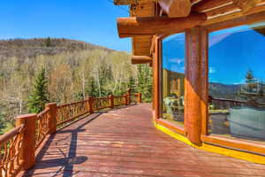 Wooden deck featuring a mountain view and a view of trees
