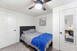 Bedroom featuring light carpet and a ceiling fan