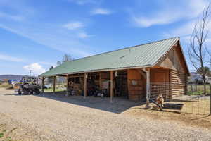 View of outdoor structure featuring a carport and an exterior structure