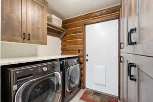 Laundry room featuring cabinet space and washer and clothes dryer