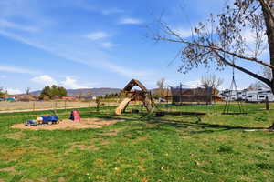 View of jungle gym featuring a trampoline