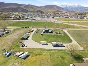Aerial view of property's location with a mountain backdrop and nearby suburban area