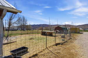 View of yard with an outbuilding, a mountain view, and a rural view