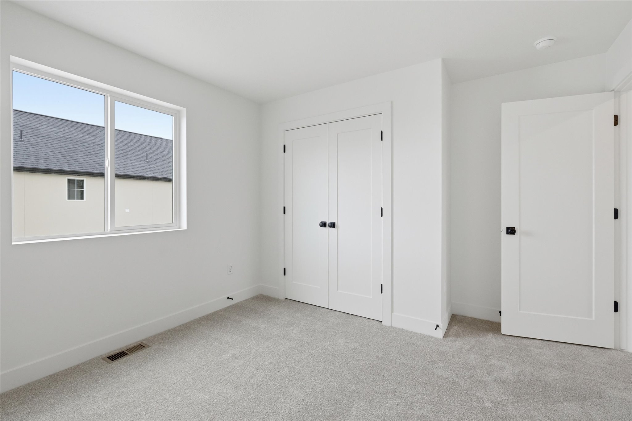 Neutral-toned carpet flooring complementing bright white walls