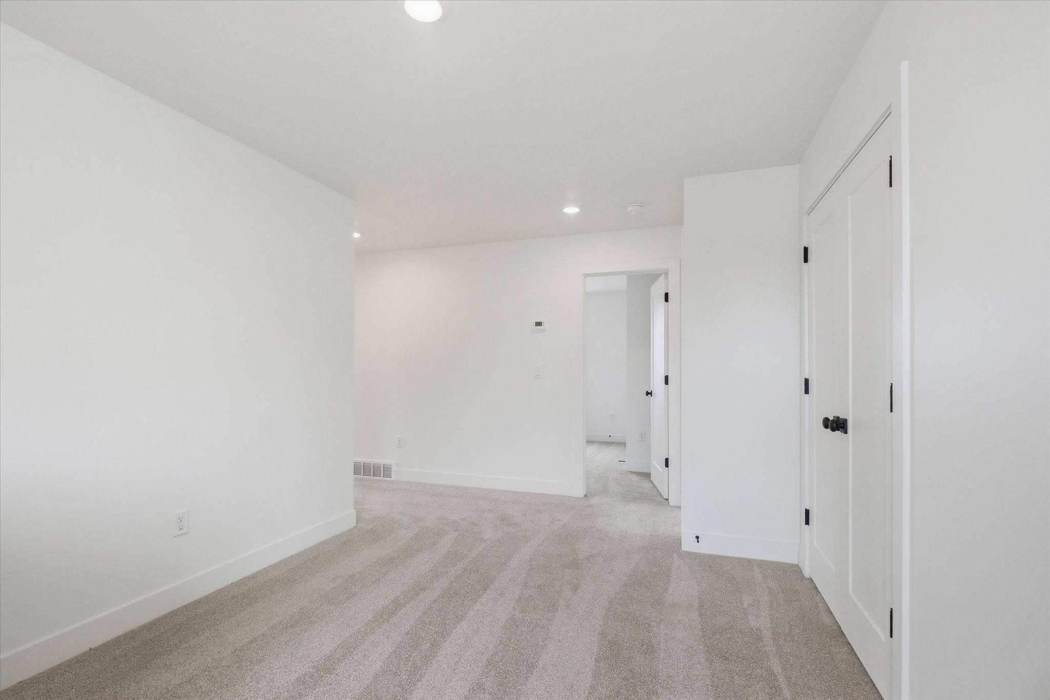 Light gray carpet flooring extending through the space