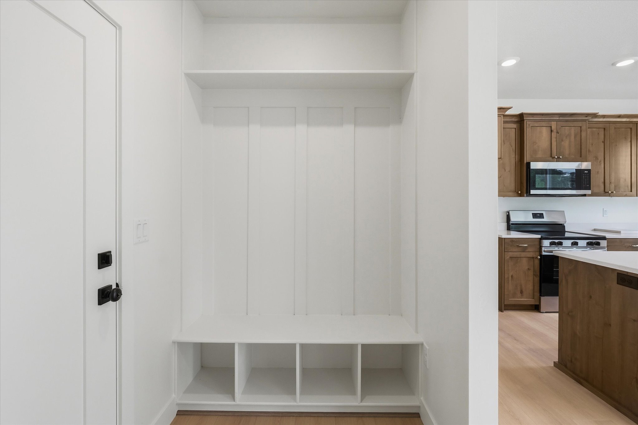Built-in entryway storage with shelving and bench seating