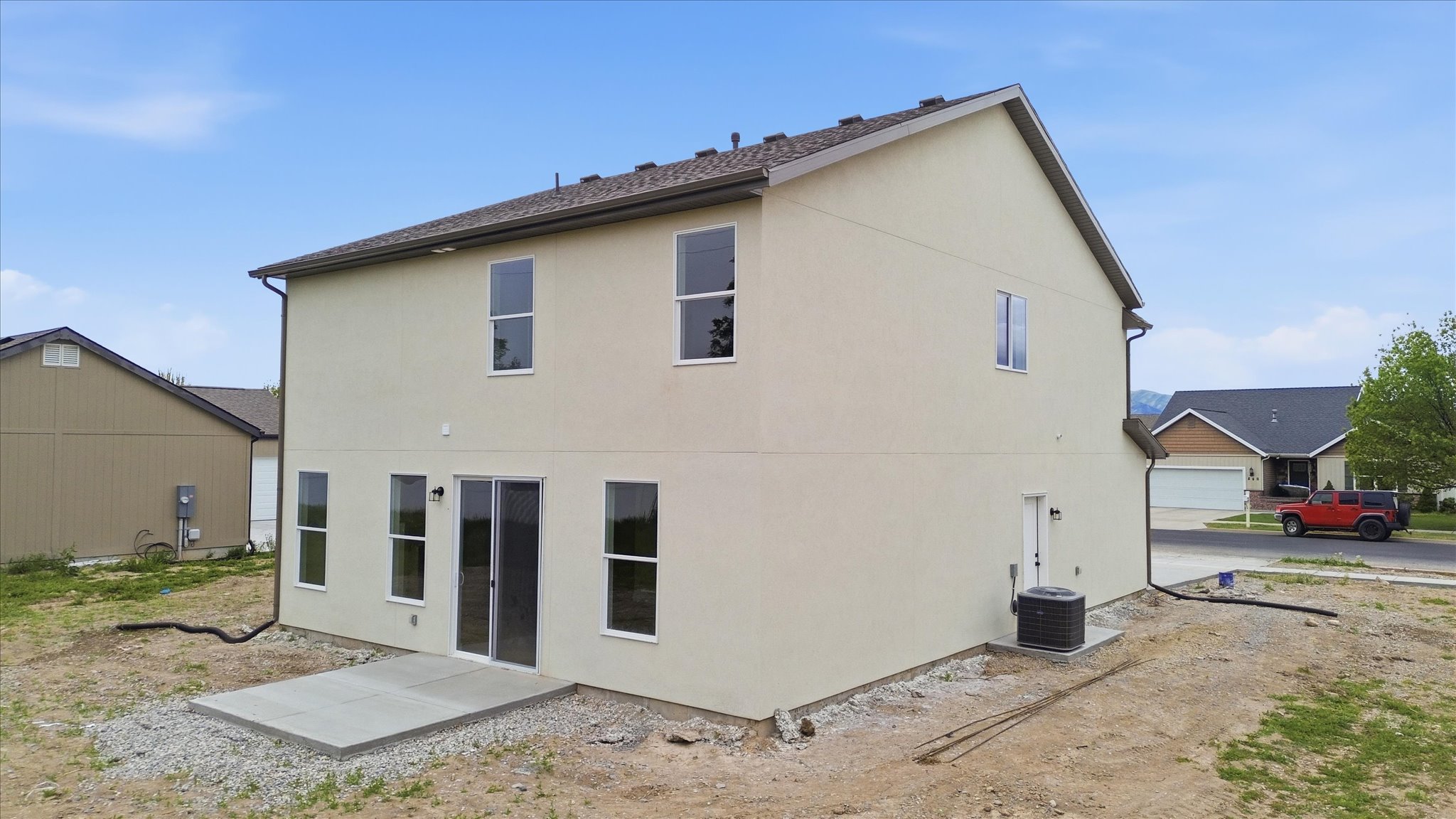 Contemporary two-story exterior with light-colored stucco siding