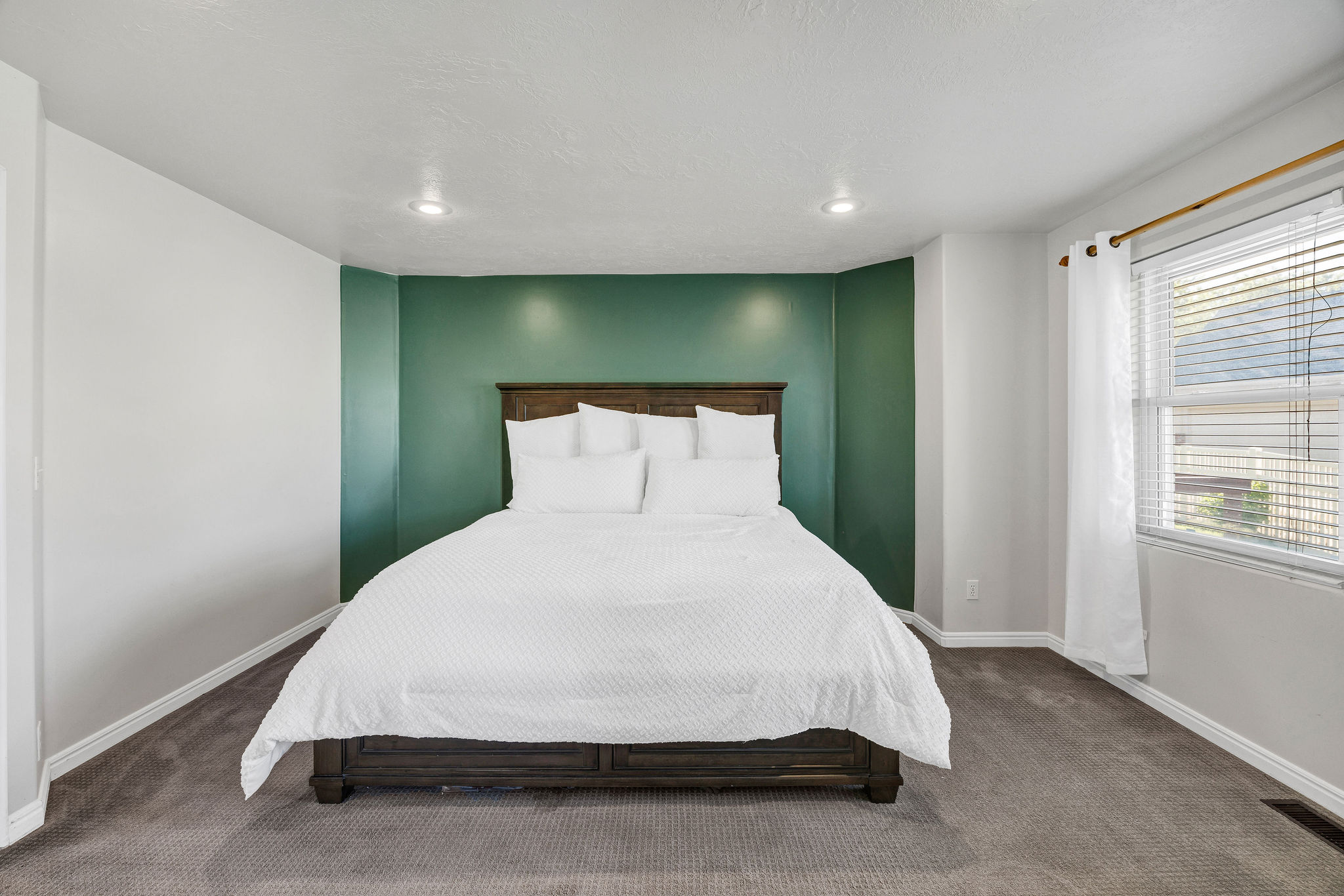 Primary Bedroom with carpet floors and recessed lighting