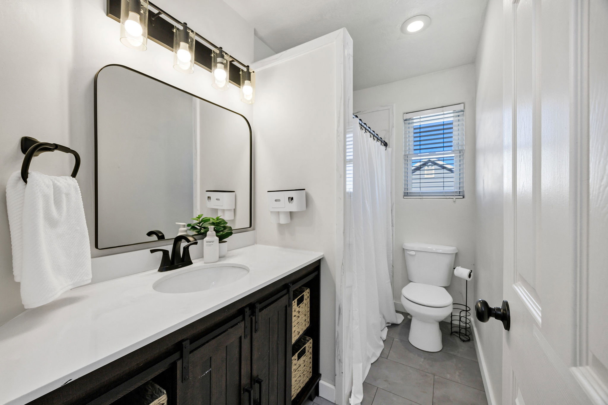 Main Full bathroom featuring vanity, a shower with curtain, light tile patterned floors, and recessed lighting