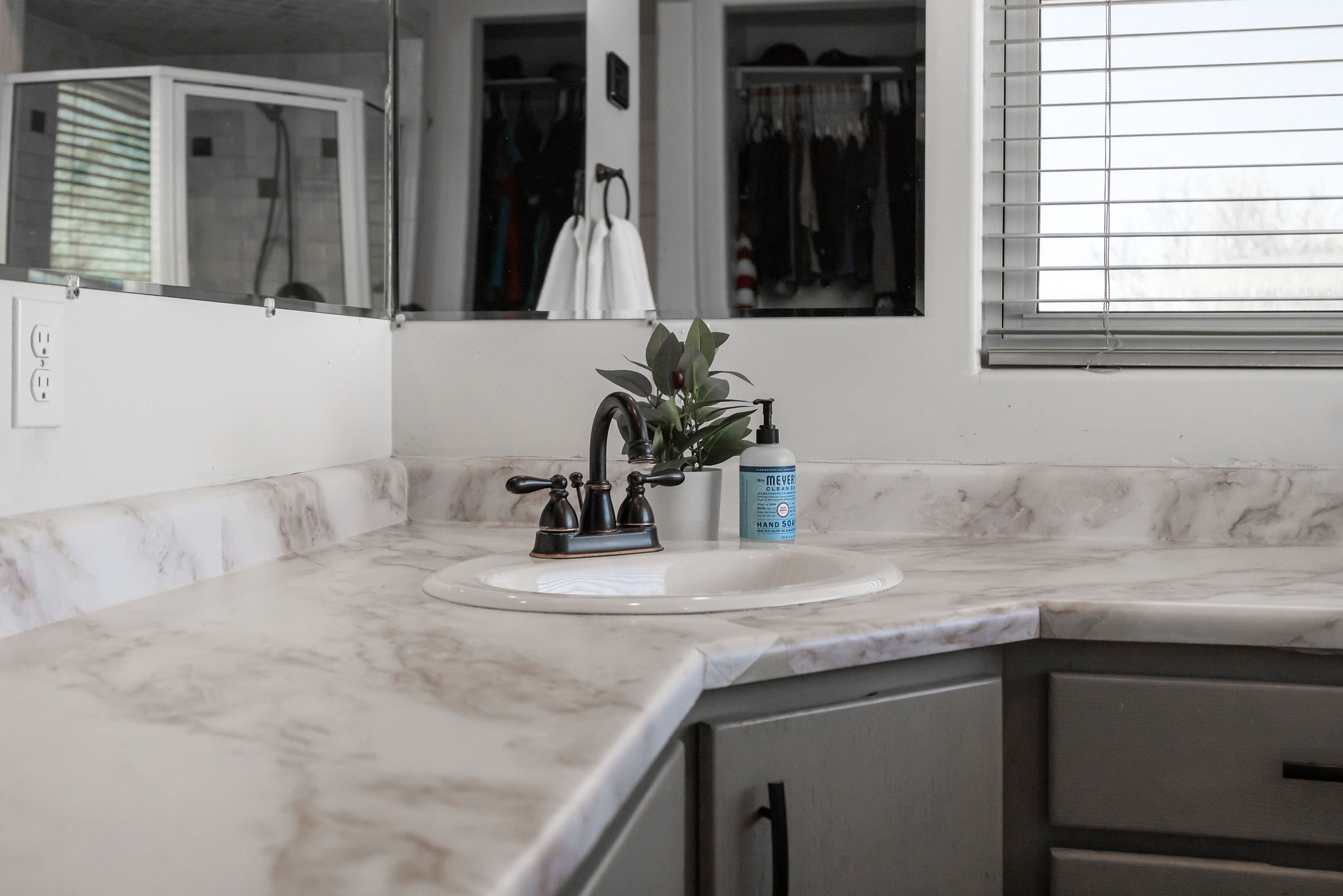 Primary Bathroom with vanity, a walk in closet, and a shower stall