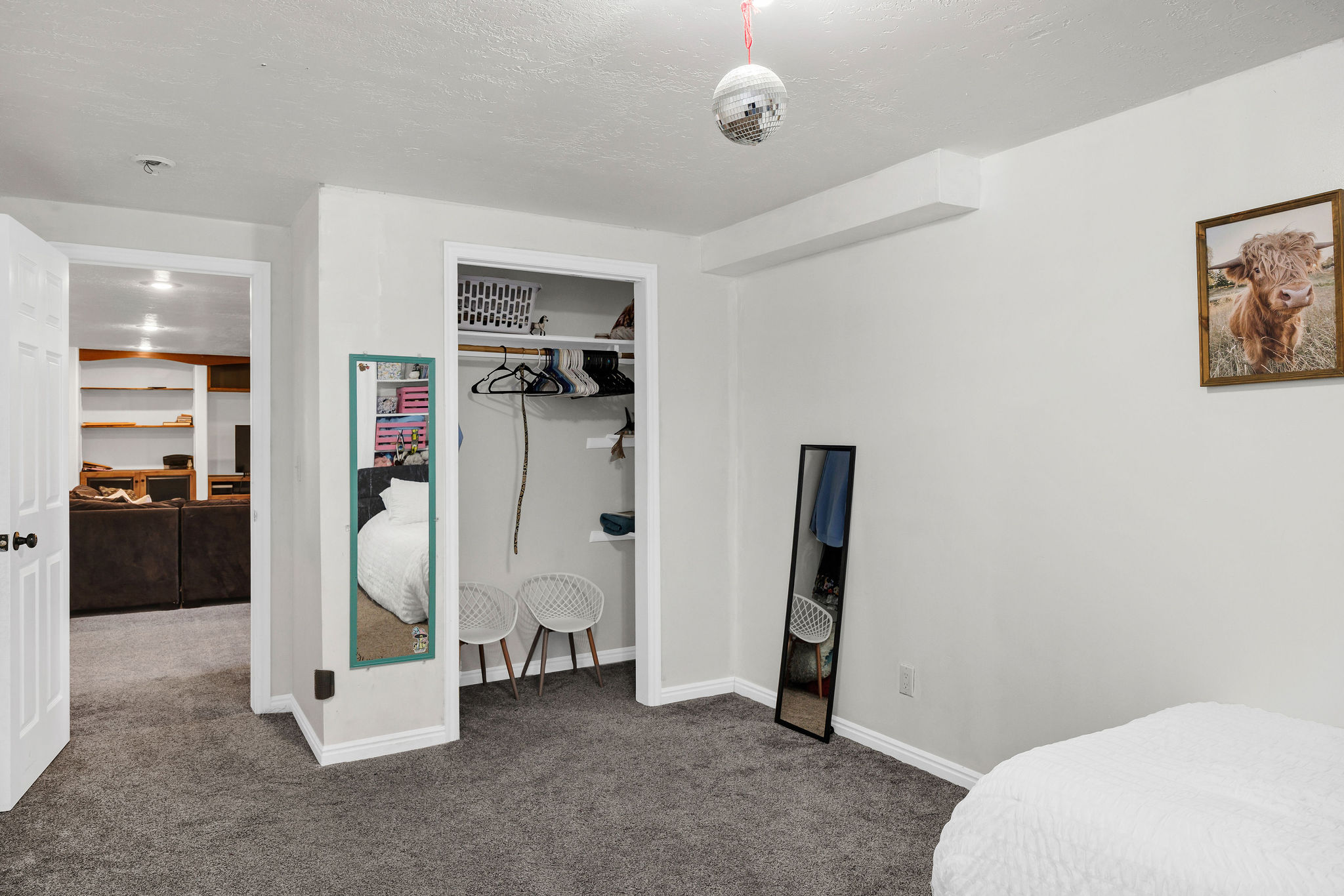 Bedroom with dark colored carpet, a closet, and a textured ceiling