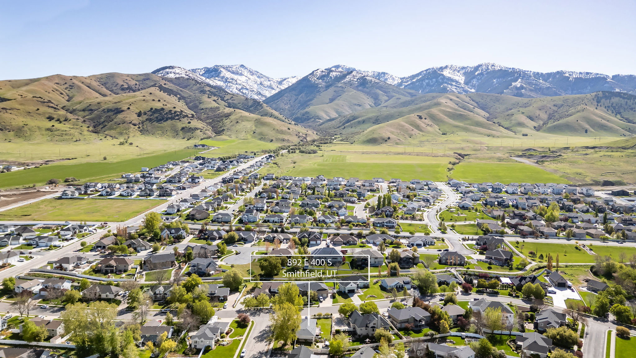 View of property location featuring mountains and nearby suburban area