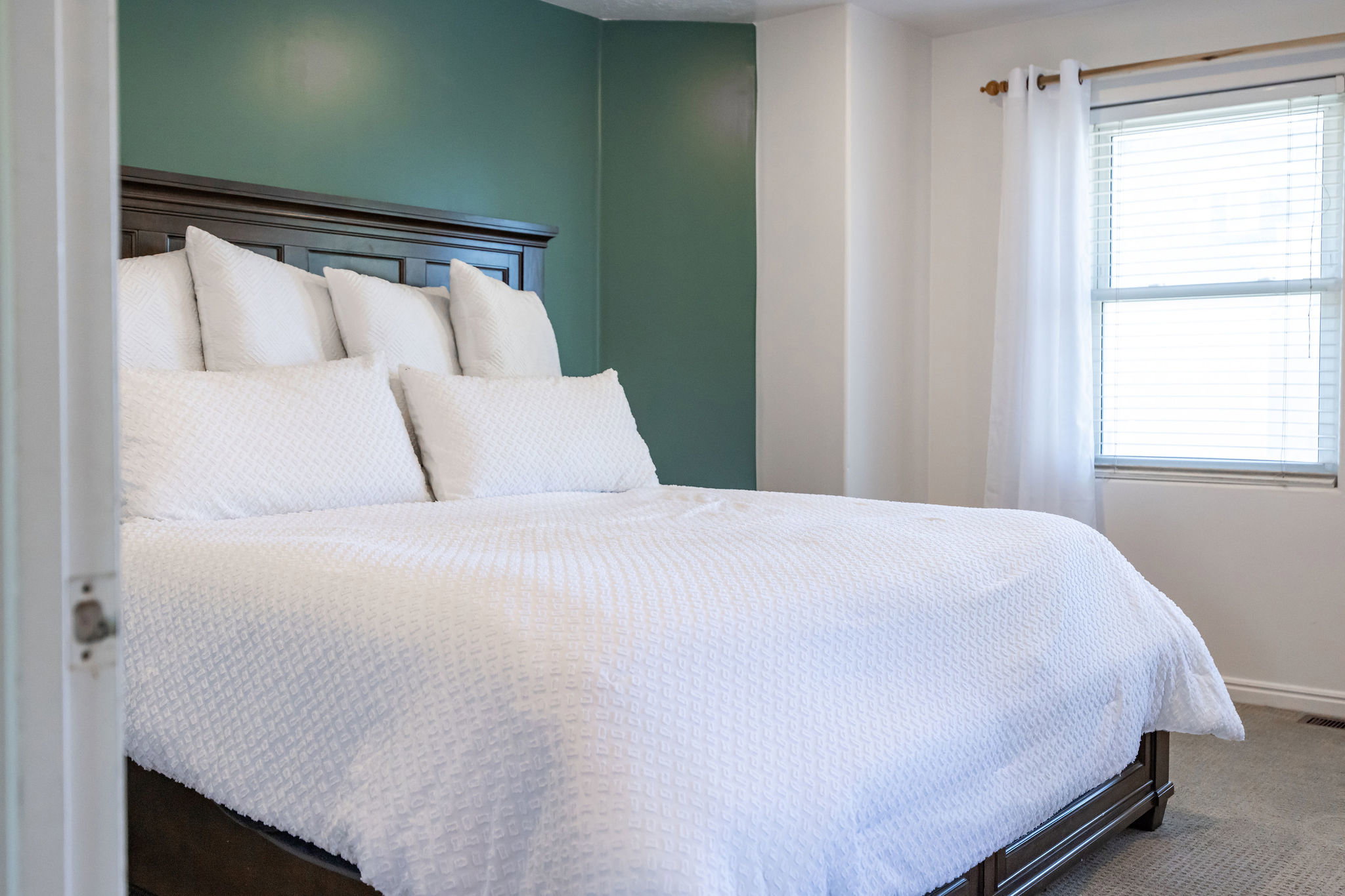 Primary Carpeted bedroom with baseboards