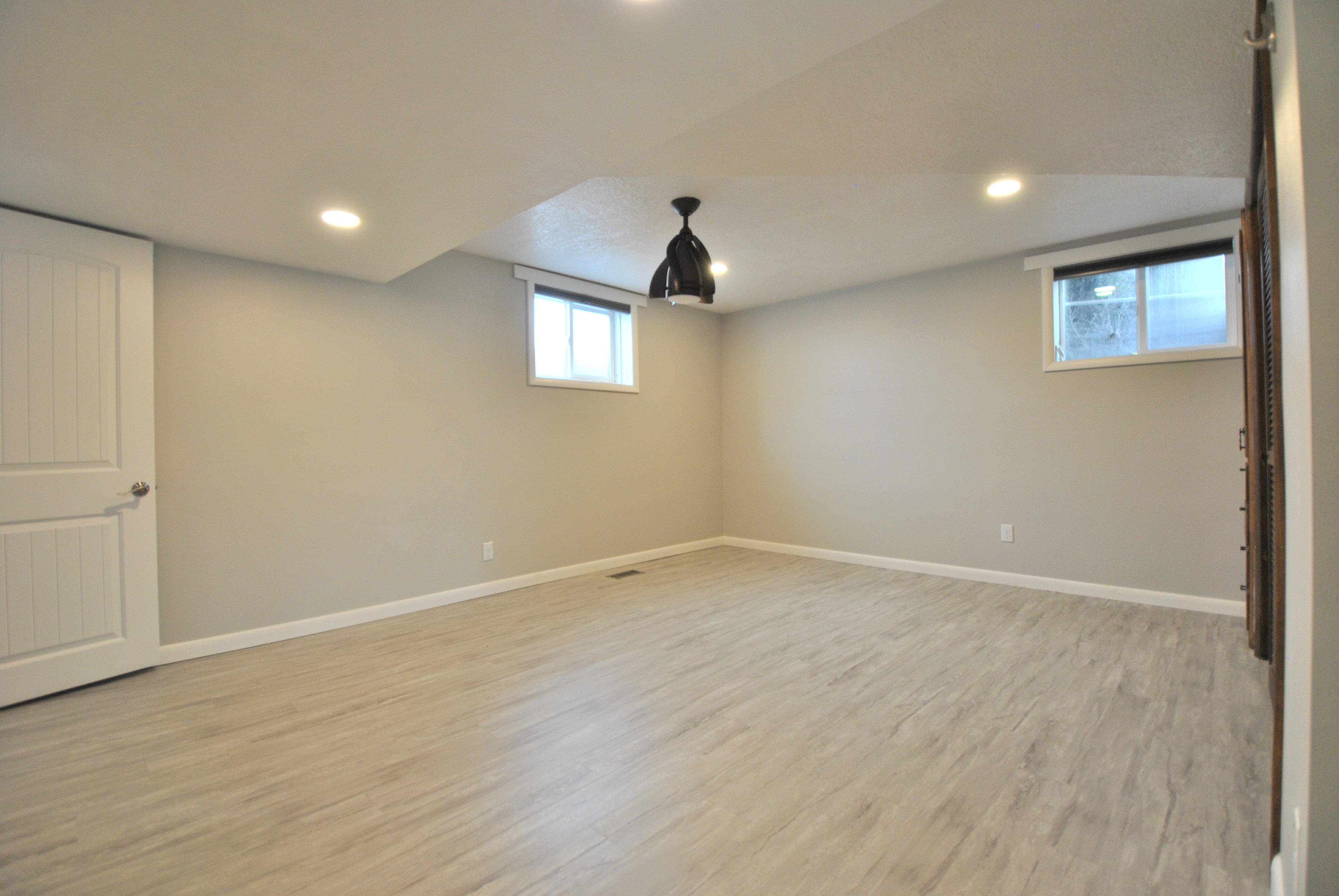 Bedroom area with light wood-style floors and recessed lighting