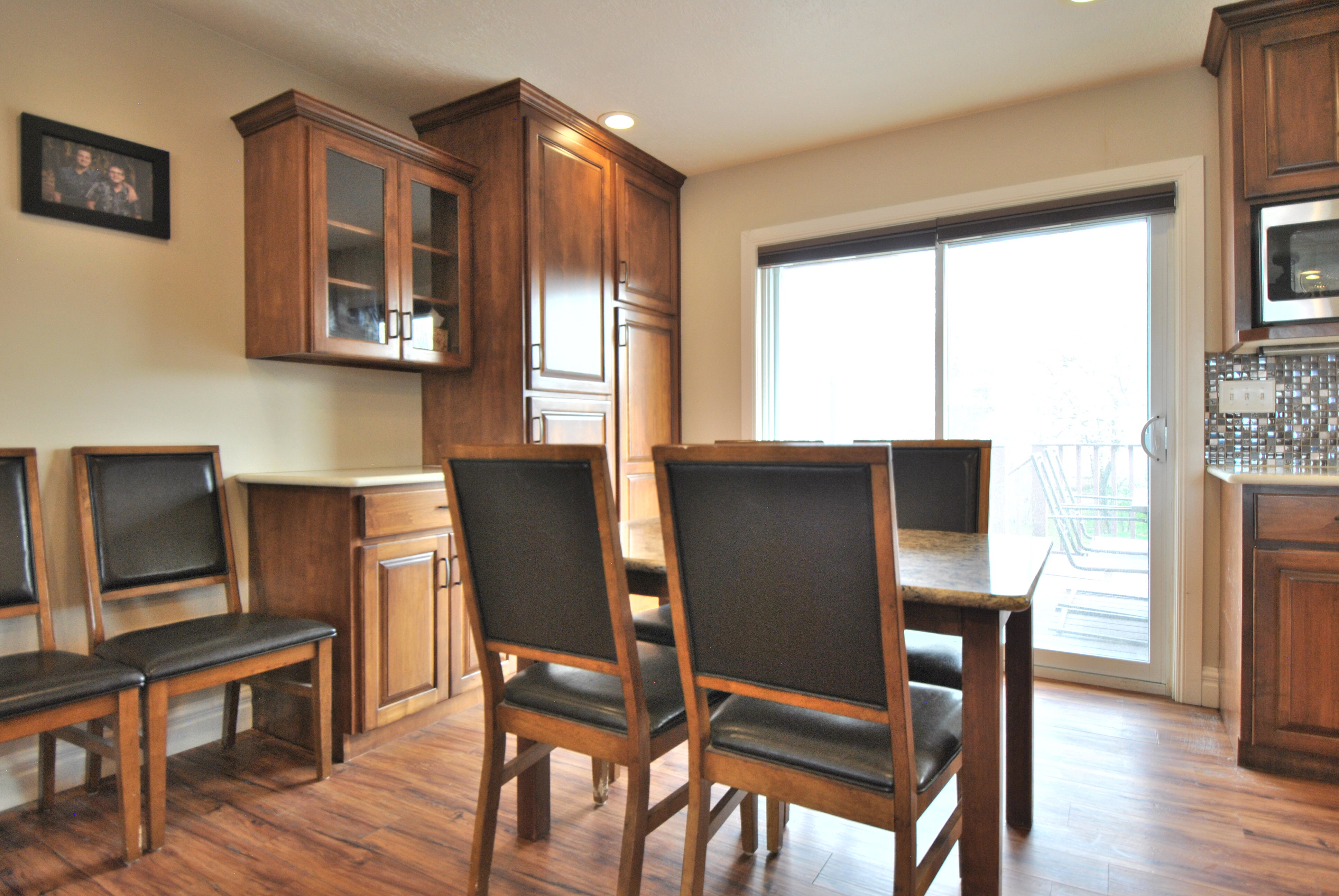 Dining area featuring dark wood-style flooring and recessed lighting