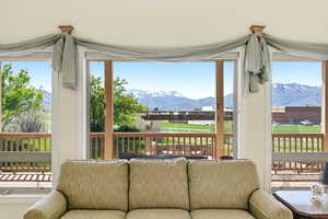 Sunroom / solarium featuring a mountain view and healthy amount of natural light