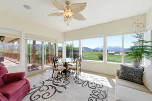 Sunroom / solarium featuring a mountain view and wood finished floors