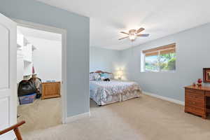 Bedroom featuring light carpet and ceiling fan