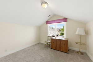 Home office with light carpet and baseboards