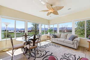 Sunroom featuring a mountain view, wood finished floors, and plenty of natural light