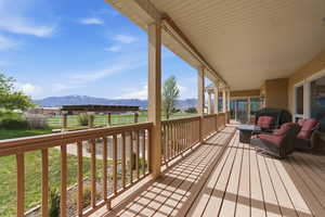 Wooden terrace with a mountain view and a lawn