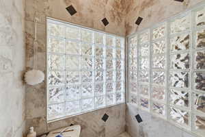 Full bath featuring a tile shower