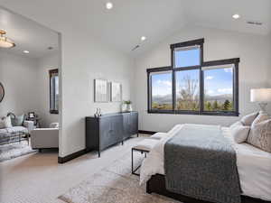 Carpeted bedroom with a high ceiling and recessed lighting