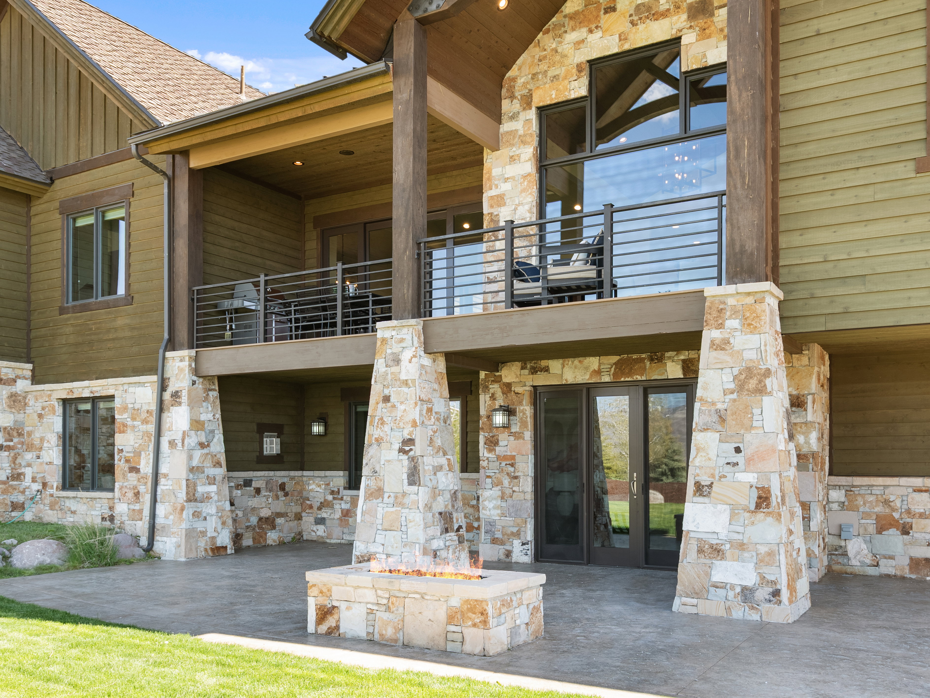 View of exterior entry with stone siding, a patio area, and french doors