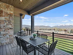 Deck featuring outdoor dining space and a mountain view