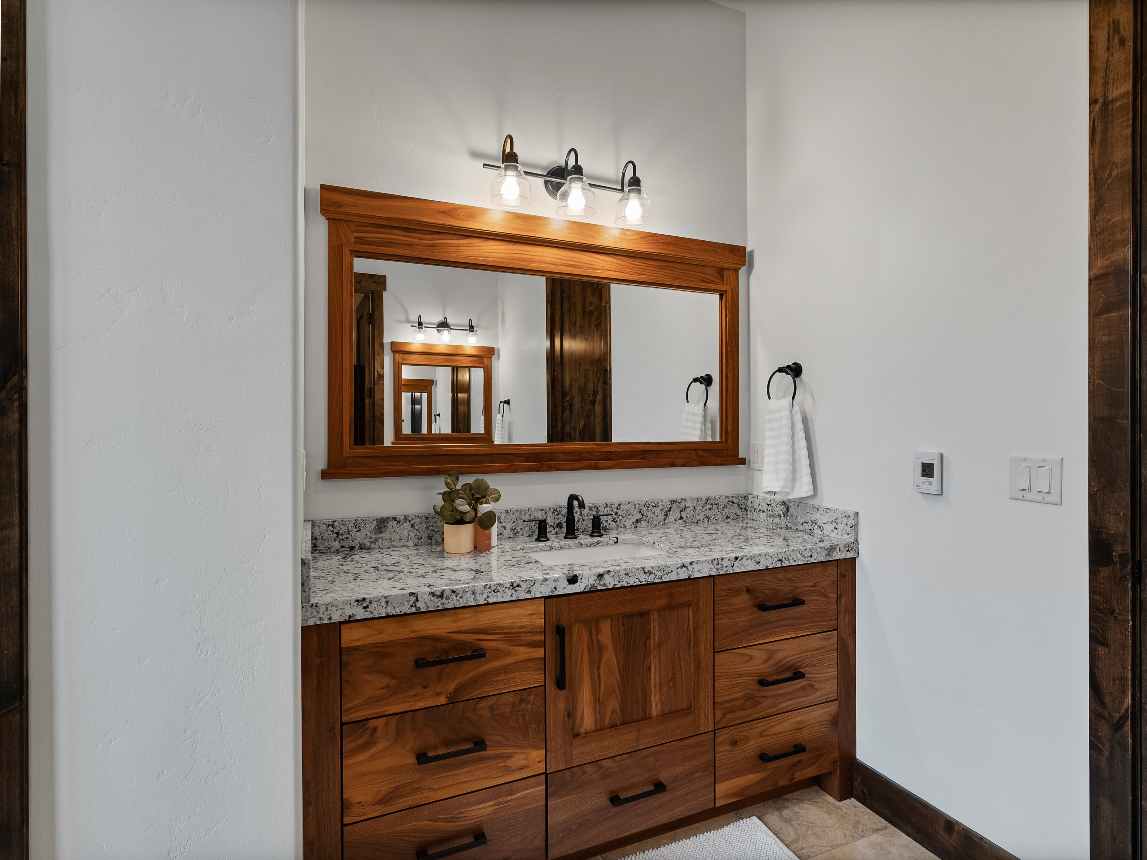 Bathroom featuring vanity and baseboards
