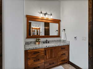 Bathroom featuring vanity and baseboards