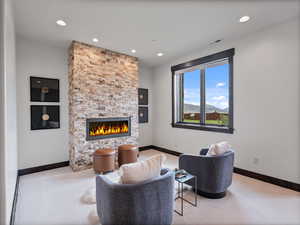 Living room with a fireplace, carpet, recessed lighting, and a mountain view