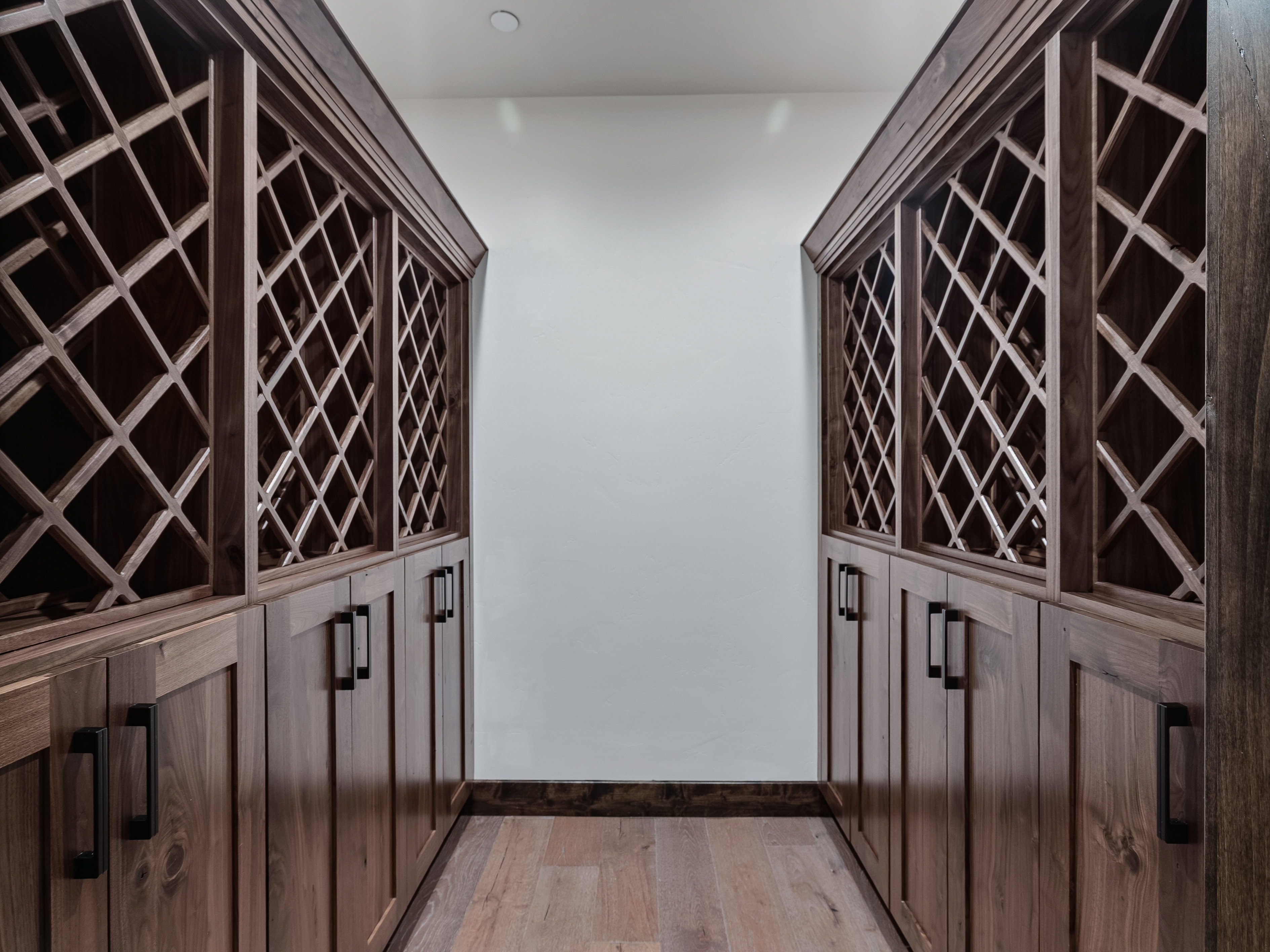Wine area with light wood finished floors and baseboards
