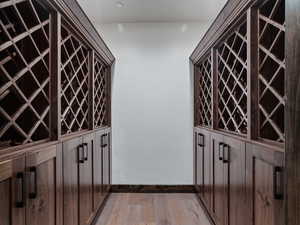 Wine area with light wood finished floors and baseboards