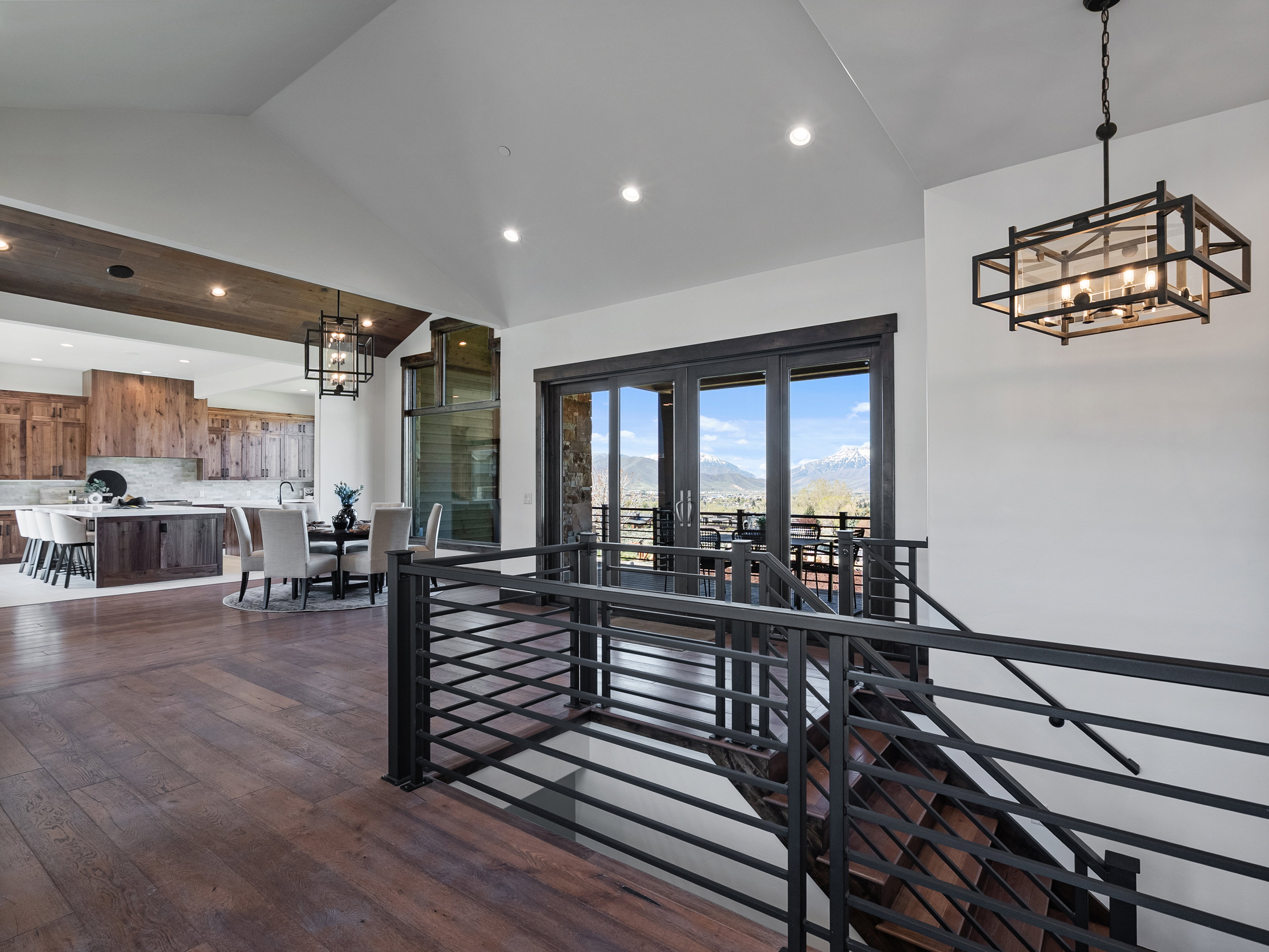 Interior space with hanging lights, dark wood-type flooring, and vaulted ceiling