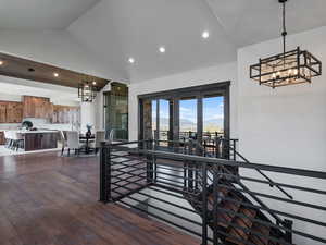 Interior space with hanging lights, dark wood-type flooring, and vaulted ceiling