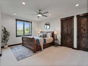Bedroom featuring light colored carpet, ceiling fan, and recessed lighting