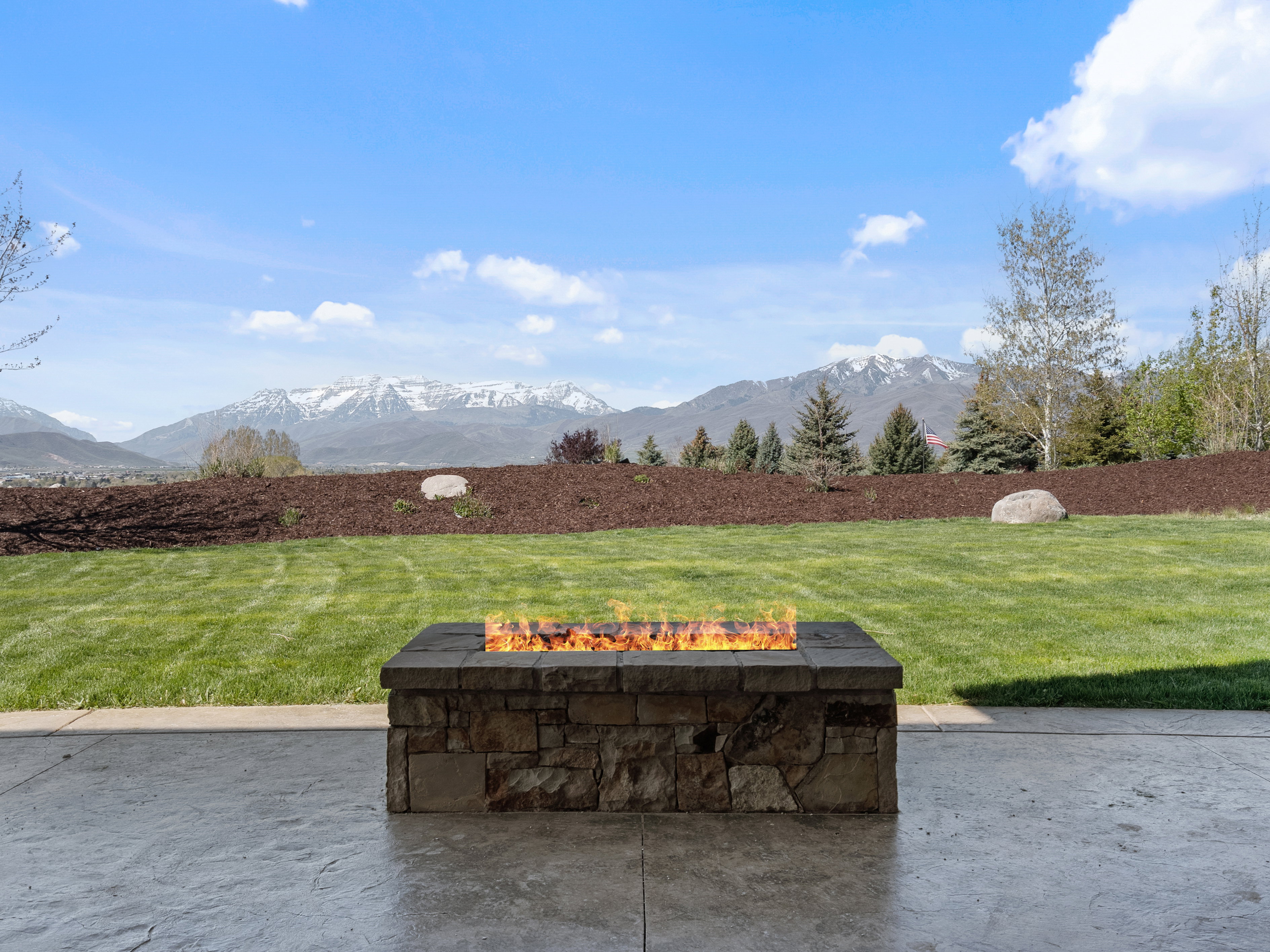 View of patio featuring a fire pit and a mountain view