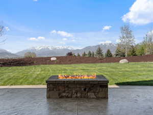 View of patio featuring a fire pit and a mountain view