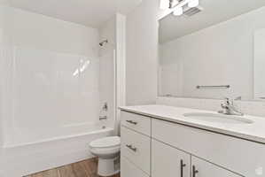 Full bathroom featuring vanity, light wood-style floors, and shower / bath combination