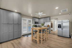 Dining room with ceiling fan, light wood finished floors, and recessed lighting