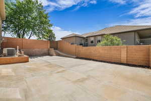 View of property exterior with a fenced backyard and a patio area