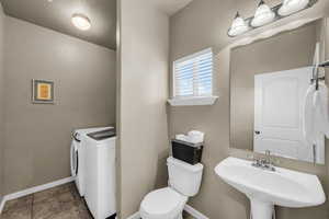 Bathroom with toilet and separate washer and dryer