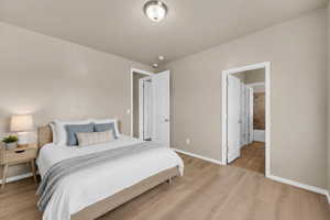 Bedroom with light wood-type flooring and baseboards