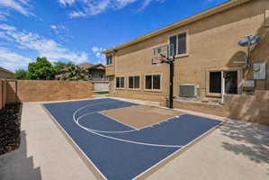 View of basketball court featuring basketball court and a fenced backyard