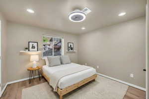 Bedroom with light wood-type flooring and recessed lighting
