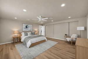 Bedroom with light wood-style floors, recessed lighting, and a ceiling fan