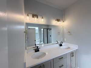 Full bathroom featuring a stall shower, double vanity, and a bath